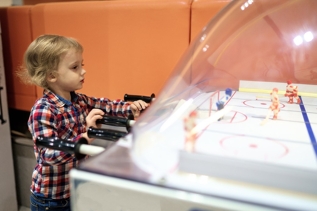 Child playing air hockey