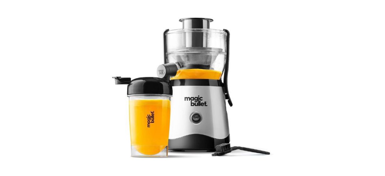 Magic Bullet Mini Juicer and cup sitting next to a cleaning brush on white background Magic Bullet Mini Juicer and cup sitting next to a cleaning brush on white background