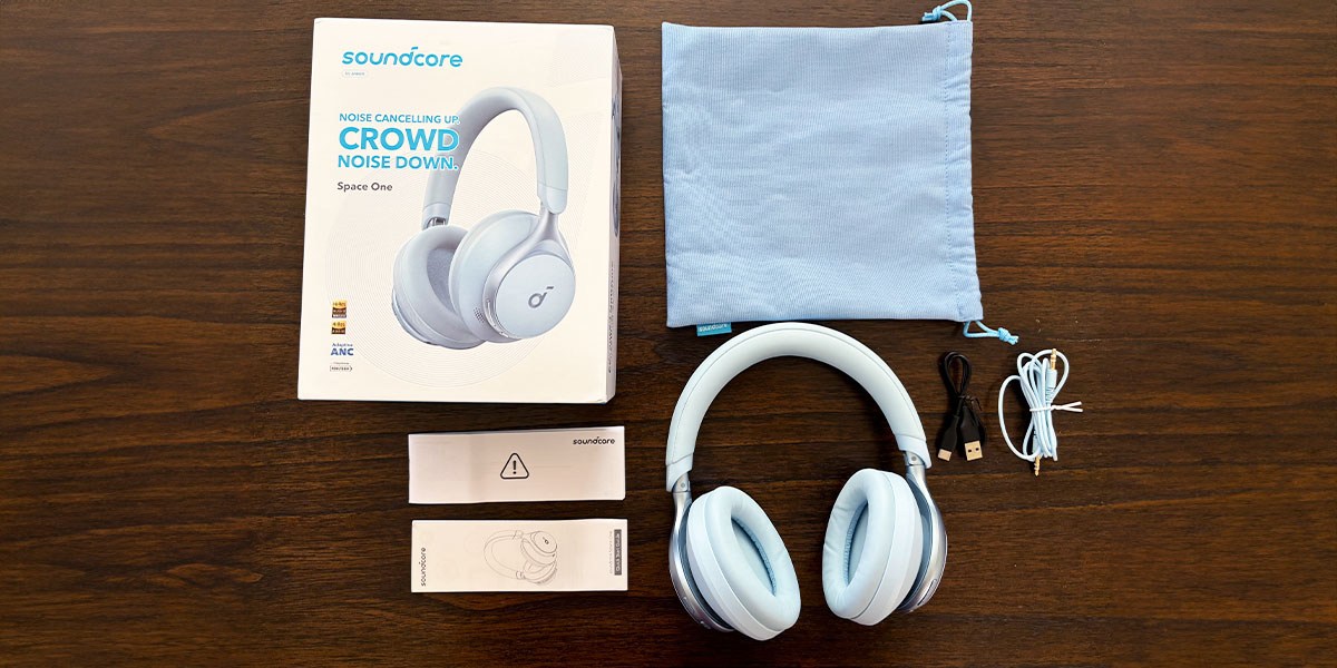 Soundcore Space One Headphones and accessories displayed on table Soundcore Space One Headphones and accessories displayed on table