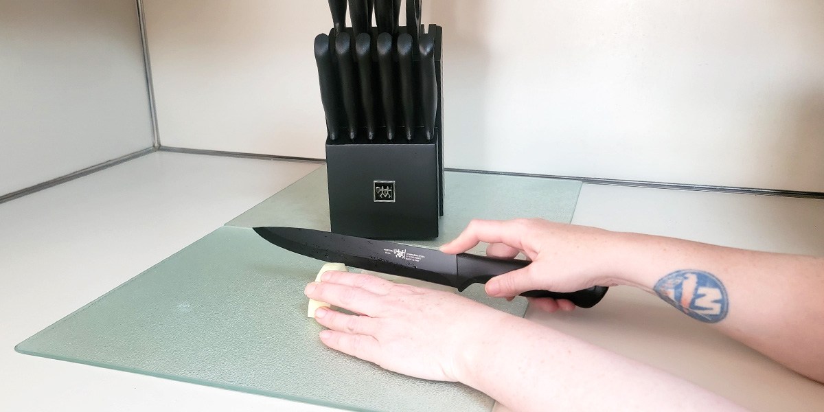 Hand using Hunter.Dual Knife Set knife to cut vegetable Hand using Hunter.Dual Knife Set knife to cut vegetable