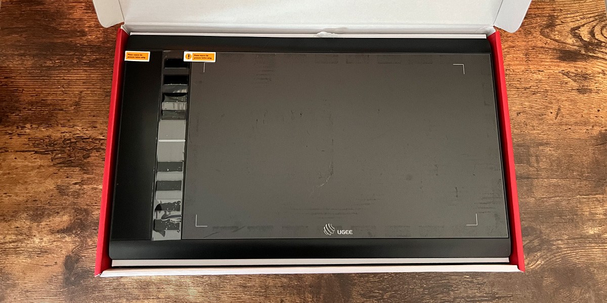 Ugee M708 Graphics Drawing Tablet in open product box Ugee M708 Graphics Drawing Tablet in open product box