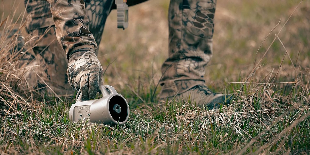 Hunter laying FoxPro Prowler on ground