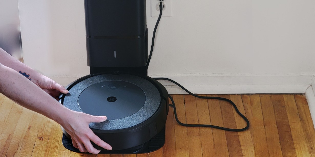 Person emptying Roomba dustbin