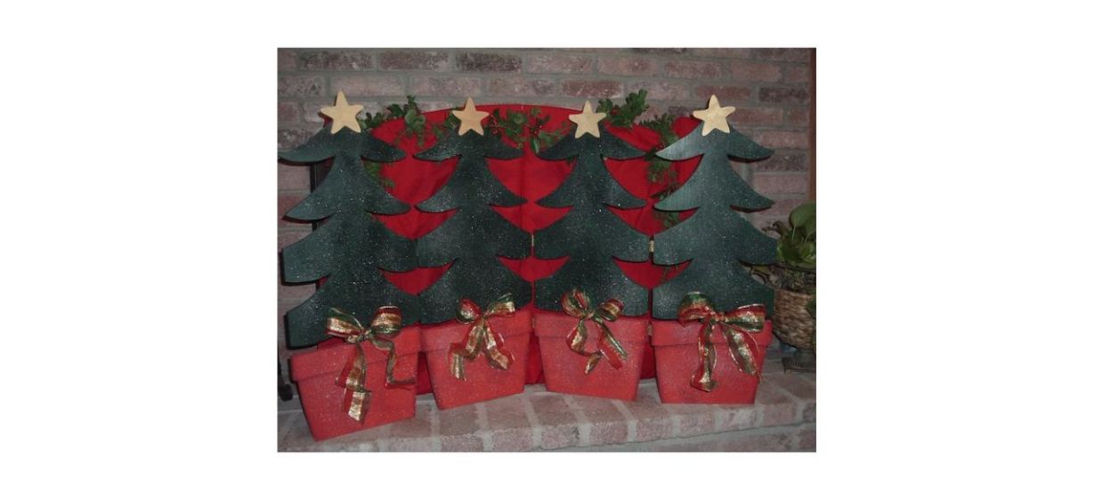 fireplace screen that looks like green Christmas trees in red pots joined together