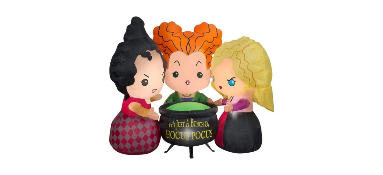 Outdoor inflatables of the Sanderson sisters from &quot;Hocus Pocus&quot; standing around a black cauldron that says &quot;it's just a bunch of hocus pocus&quot;