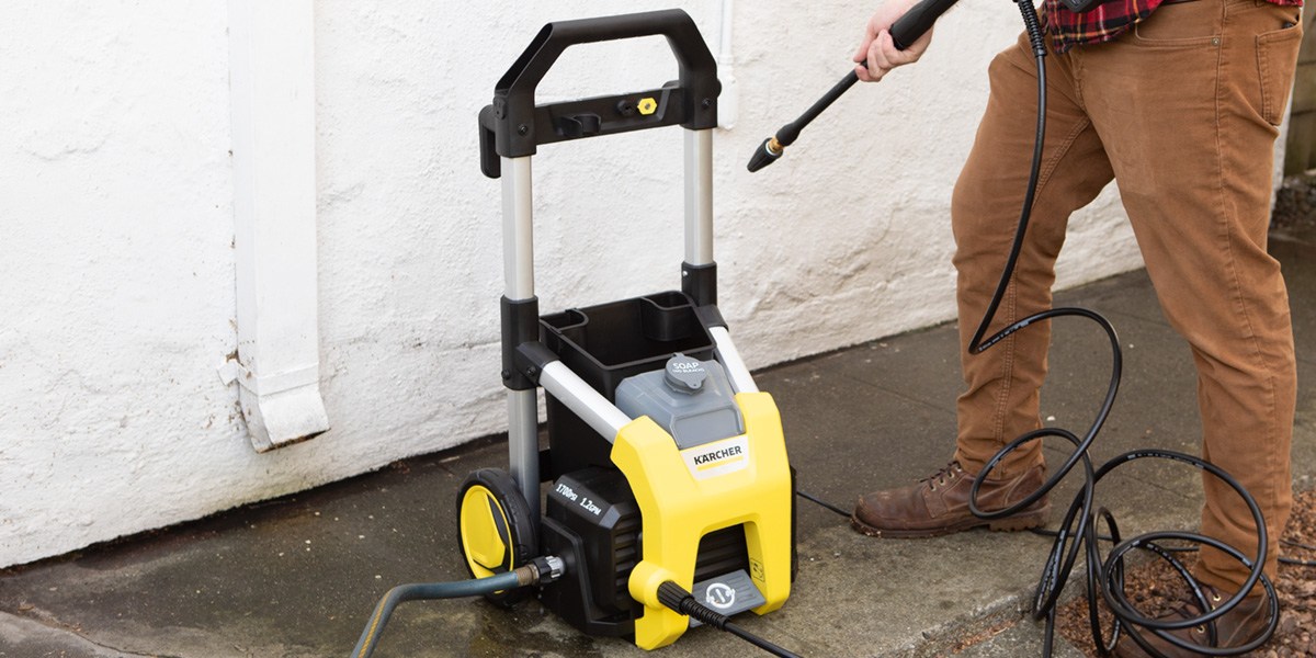 Person using Kärcher K1700 to wash side of house
