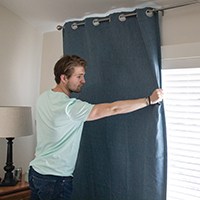 Person hanging curtain